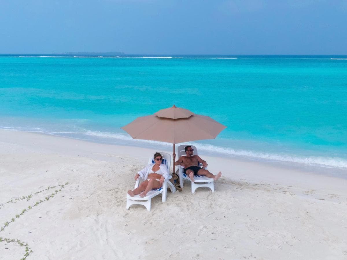 Loungers and a parasol on the beach at Gaafaru